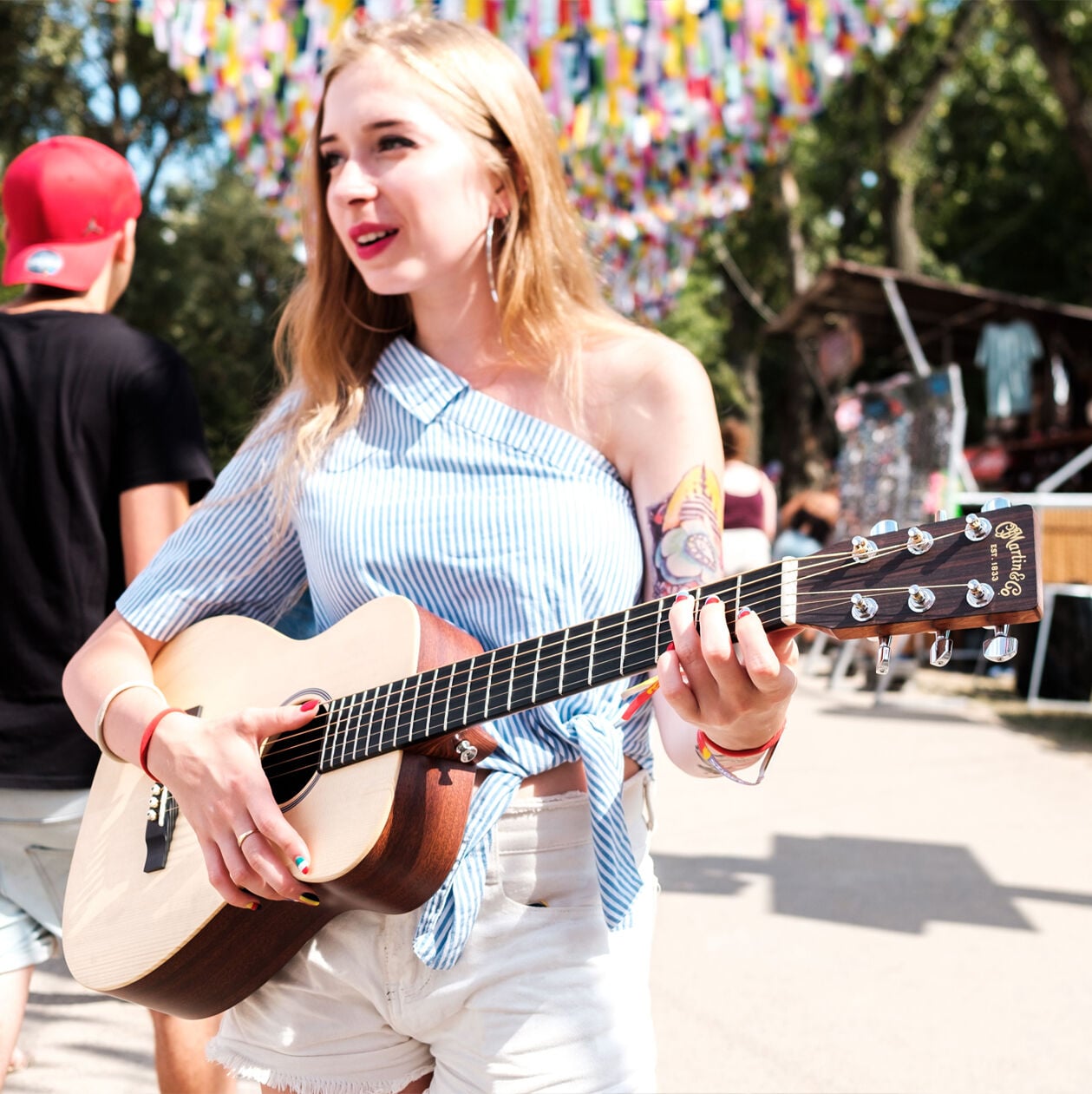 Woman playing an acoustic guitar outside